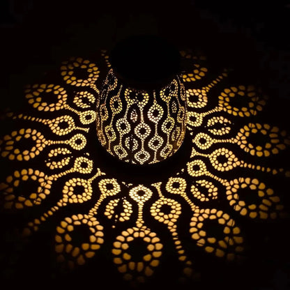 Decorative lamp casting intricate patterns on a dark background