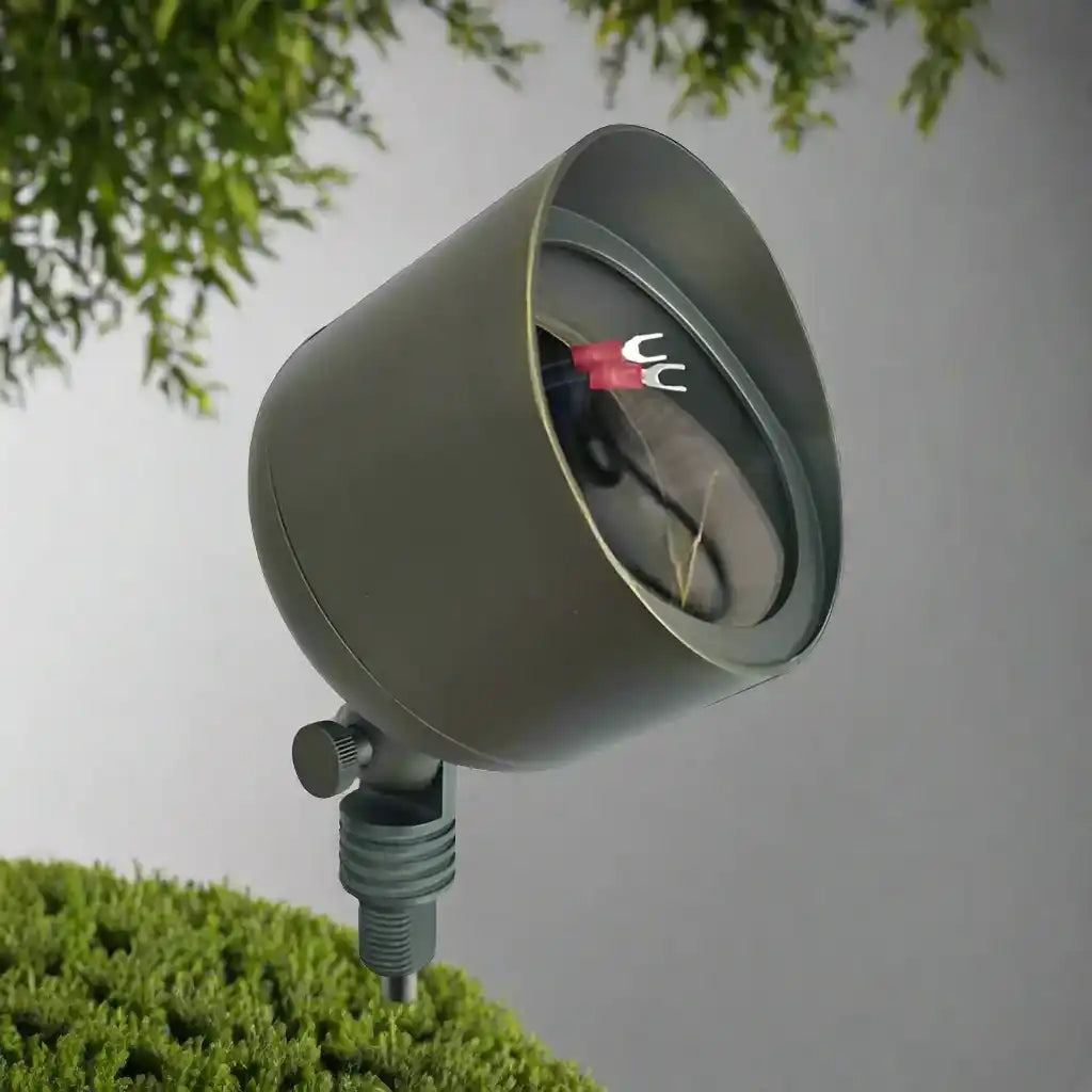 Olive green outdoor spotlight fixture with an adjustable mounting base.