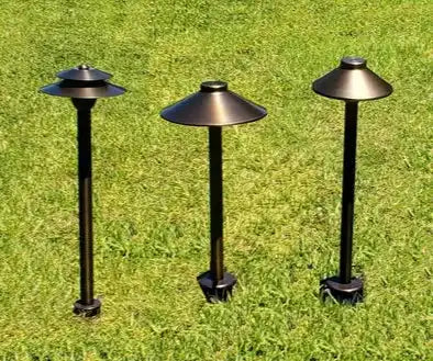 Three black metal outdoor path lights with disc-shaped shades.