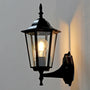 Black outdoor wall light fixture on a gray wall